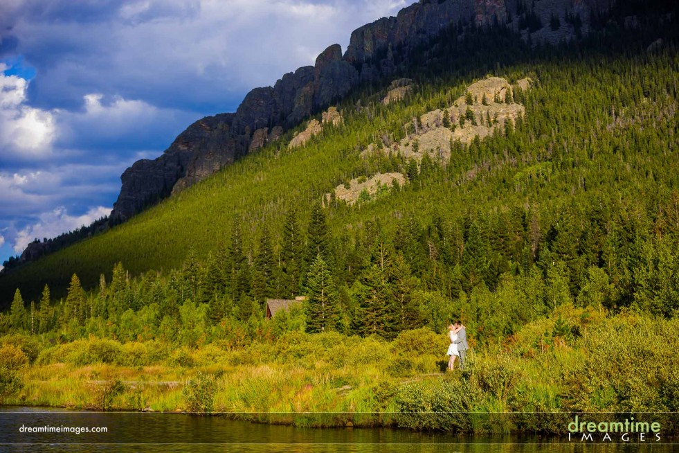 A wedding elopement portrait on the edge of Lily Lake in Estes Park