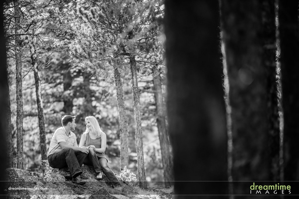 Engaged couple in the forest of Rocky Mountain National Park