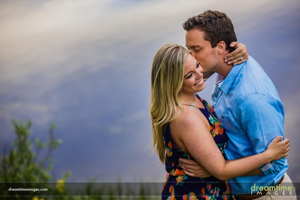 A couple kisses on the shore of Lily Lake